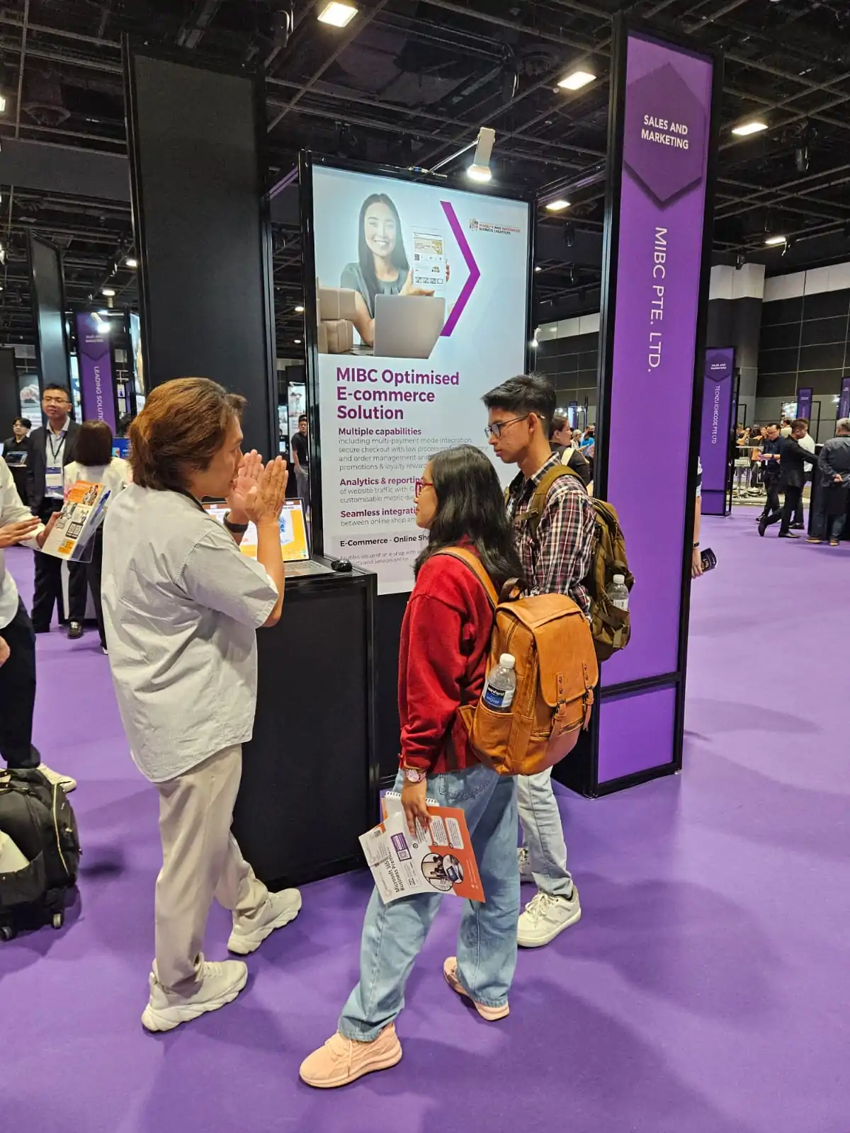 MIBC team member speaking with visitors at the SMEs Go Digital Day 2025 booth