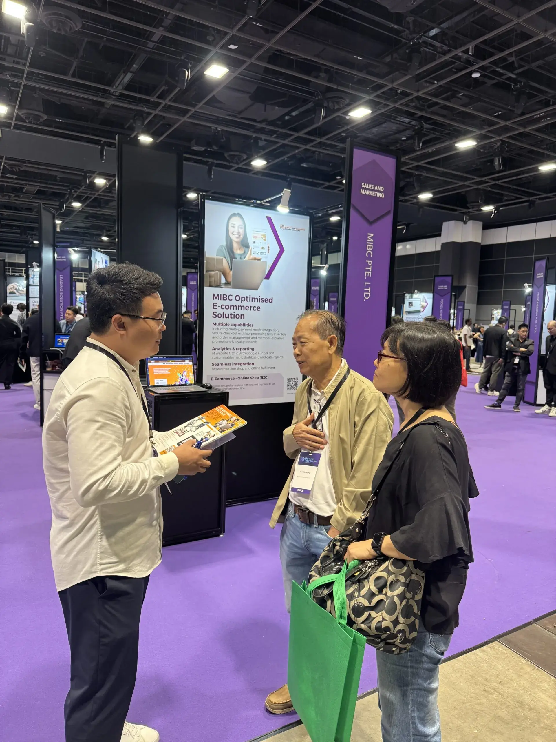 MIBC team member speaking with visitors at the SMEs Go Digital Day 2025 booth